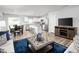 Inviting living room with open floor plan, hardwood floors, and modern decor and stainless steel appliances at 252 Elyse Overlook Loop, Sanford, NC 27332