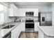 Modern kitchen with stainless steel appliances, granite countertops, white cabinets, and contemporary finishes at 254 Elyse Overlook Loop, Sanford, NC 27332