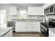 Stylish kitchen showcasing white cabinets, granite countertops, stainless steel appliances, and a modern design at 254 Elyse Overlook Loop, Sanford, NC 27332