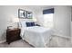 Cozy bedroom with blue and white bedding, bedside tables, lamps, and framed wall art at 256 Elyse Overlook Loop, Sanford, NC 27332