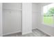 Walk-in closet with white walls, gray carpet, shelving, and a window for natural light at 256 Elyse Overlook Loop, Sanford, NC 27332
