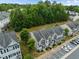 A high angle of townhomes with parking spaces, manicured lawns, and surrounding mature trees at 2713 Wyntercrest Ln, Durham, NC 27713
