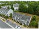 Birds-eye view of townhomes with parking, mature greenery, and neighboring buildings in a community setting at 2713 Wyntercrest Ln, Durham, NC 27713