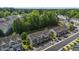 Aerial view of well-maintained townhomes with lush green trees in the background and parking spaces at 2713 Wyntercrest Ln, Durham, NC 27713