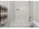 A bright bathroom with a soaking tub and shower combination with white tile at 2713 Wyntercrest Ln, Durham, NC 27713