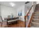 Cozy dining room with wooden floors, wooden table with bench, and views of the staircase at 2713 Wyntercrest Ln, Durham, NC 27713