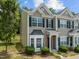Inviting townhome featuring charming architectural details and manicured landscaping at 2713 Wyntercrest Ln, Durham, NC 27713