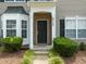 Charming front entrance features brick accents and decorative shrubs at 2713 Wyntercrest Ln, Durham, NC 27713