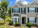 Charming two-story townhome with black shutters, manicured landscaping and front door at 2713 Wyntercrest Ln, Durham, NC 27713