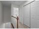 Upstairs hallway with railing, closet and view of front entrance at 2713 Wyntercrest Ln, Durham, NC 27713