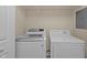 Convenient laundry room with modern washer and dryer units and wire rack at 2713 Wyntercrest Ln, Durham, NC 27713