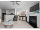 Bright living room featuring a fireplace, ceiling fan, and adjacent view into the kitchen at 2713 Wyntercrest Ln, Durham, NC 27713
