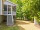 Exterior view of screened in porch and stairs leading to backyard with trees at 275 N Farm Dr, Clayton, NC 27527