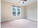 Neutral bedroom featuring neutral walls, plush carpet floors, and a bright window at 275 N Farm Dr, Clayton, NC 27527