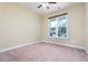 Neutral bedroom featuring neutral walls, plush carpet floors, and a bright window at 275 N Farm Dr, Clayton, NC 27527