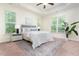 Bright main bedroom featuring large windows, trey ceiling, ceiling fan and neutral color palette at 275 N Farm Dr, Clayton, NC 27527