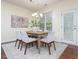 Bright dining room with a modern chandelier, seating for six, and plenty of natural light at 275 N Farm Dr, Clayton, NC 27527