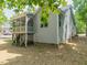 Exterior of home with screened-in porch and gray siding and mature trees at 275 N Farm Dr, Clayton, NC 27527