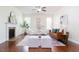 Bright living room featuring a fireplace, plenty of seating, and hardwood floors at 275 N Farm Dr, Clayton, NC 27527