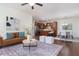 Open concept living room flows to kitchen and dining, featuring hardwood floors and modern decor at 275 N Farm Dr, Clayton, NC 27527