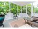 Relaxing screened-in porch featuring comfortable seating, a neutral rug, and lovely views of the surrounding trees at 275 N Farm Dr, Clayton, NC 27527