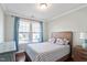 Cozy bedroom with a bed, windows with curtains, and a hardwood floor at 2919 Winter Crop Way, Apex, NC 27502