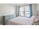 Bright bedroom showcasing a bed, dresser, and window with blue curtains at 2919 Winter Crop Way, Apex, NC 27502