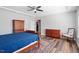 Bedroom with stylish ceiling fan, hardwood floors, and a large dresser at 2919 Winter Crop Way, Apex, NC 27502