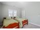 Bedroom featuring two twin beds with decorative pillows and a ceiling light at 2919 Winter Crop Way, Apex, NC 27502