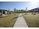 Landscaped community walking path with benches and pergola for relaxing within green spaces at 2919 Winter Crop Way, Apex, NC 27502