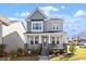 Charming two-story home featuring a welcoming front porch with stone accents and beautifully landscaped yard at 2919 Winter Crop Way, Apex, NC 27502