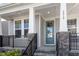 Inviting front porch featuring stone accents, providing a cozy outdoor seating area at 2919 Winter Crop Way, Apex, NC 27502