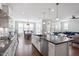 Bright kitchen flows into the dining area, featuring hardwood floors and stainless appliances at 2919 Winter Crop Way, Apex, NC 27502