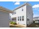 Home's rear exterior with a screened porch and detached garage, offering a comfortable outdoor space at 2919 Winter Crop Way, Apex, NC 27502