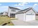 Home's rear exterior with a screened porch and detached garage, offering a comfortable outdoor space at 2919 Winter Crop Way, Apex, NC 27502