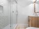 Stylish bathroom with glass shower and a vanity with wicker-style cabinetry at 3009 Hillmer Dr, Raleigh, NC 27609