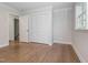 Bedroom with hardwood floors, closet, and entry to an additional room at 3009 Hillmer Dr, Raleigh, NC 27609