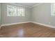 Clean and bright bedroom with hardwood floors, neutral walls, and a large window at 3009 Hillmer Dr, Raleigh, NC 27609