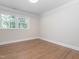 A sunlit room with hardwood floors and white trim offers a clean, bright aesthetic at 3009 Hillmer Dr, Raleigh, NC 27609