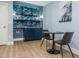 Stylish dining nook with blue accent wall, built in bar, and seating for a cozy entertaining space at 3009 Hillmer Dr, Raleigh, NC 27609