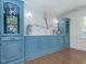 Elegant dining room featuring custom blue cabinets and hardwood flooring at 3009 Hillmer Dr, Raleigh, NC 27609