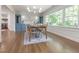 Well-lit dining room with a rustic table and chairs, complemented by custom blue cabinetry at 3009 Hillmer Dr, Raleigh, NC 27609
