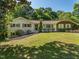 Charming single-story home with brick and siding, front yard with mature trees and manicured landscaping at 3009 Hillmer Dr, Raleigh, NC 27609