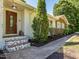 Charming front entrance with brick stairs, decorative greenery, and a welcoming front door at 3009 Hillmer Dr, Raleigh, NC 27609