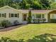 Charming front exterior with brick facade, well-manicured landscaping, and a cozy front porch entrance at 3009 Hillmer Dr, Raleigh, NC 27609