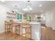 Bright kitchen features island seating, stone countertops, decorative shelves, and stainless steel appliances at 3009 Hillmer Dr, Raleigh, NC 27609