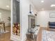 Cozy living room boasts a modern fireplace with log storage and beautiful hardwood floors at 3009 Hillmer Dr, Raleigh, NC 27609