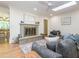 Living room with hardwood flooring features a fireplace, skylights, and comfortable seating at 3009 Hillmer Dr, Raleigh, NC 27609