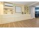Spacious living area with built-in shelving, wood look flooring and ductless AC for comfort and style at 3009 Hillmer Dr, Raleigh, NC 27609