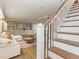 Bright living room features stylish stairs, recessed lighting, and built-in shelving for storage and display at 3009 Hillmer Dr, Raleigh, NC 27609